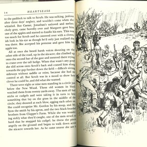 May include: An open book with a black and white illustration depicting a group of men in a field, some holding sticks, and a few women watching. The text on the page reads "HEARTSEASE".