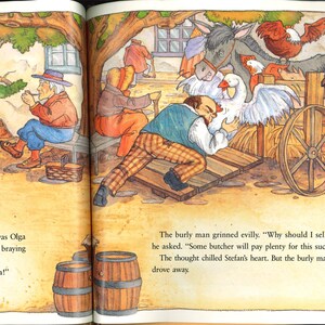 May include: A vibrant illustration from a children's book shows a lively village scene. A man examines a cart filled with animals, including a goose, chickens, and a goat. Other figures are in the background, with text at the bottom.