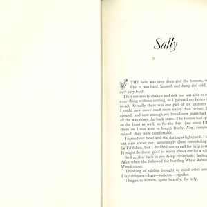 May include: Open book with text on two facing pages. The title "Sally" is at the top of the right page. The text is in black font on a cream-colored background. The text describes a fall and the narrator's thoughts.