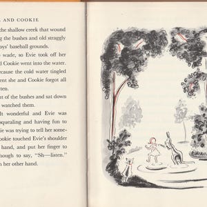 May include: A black and white illustration of a girl and a kangaroo standing in a shallow creek. The girl is wearing a red dress and the kangaroo is standing on its hind legs. There are trees in the background.