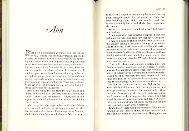 May include: Open book with text. The left page features the title "Ann" in elegant script and a passage beginning "AFTER the miserable evening I had spent at the social...". The right page continues the text, with the page number "45" at the top.