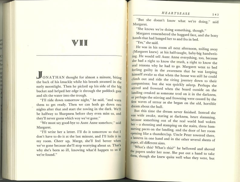 May include: Open book with text on both pages. The left page has a chapter title "VII" and the beginning of a story. The right page has the title "HEARTSEASE" and more text. The pages are aged with a yellowed tone.