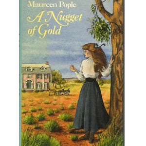 May include: Book cover illustration for "A Nugget of Gold" by Maureen Pople. The cover features a woman in a white blouse and long blue skirt standing near a tree. A pink house and a horse-drawn carriage are in the background. The title is in gold script.