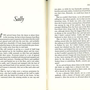 May include: Open book with text on both pages. The left page features the title "Sally" and a floral design. The right page has the number "71" at the top and continues the story. The pages are aged with a yellowed tone.