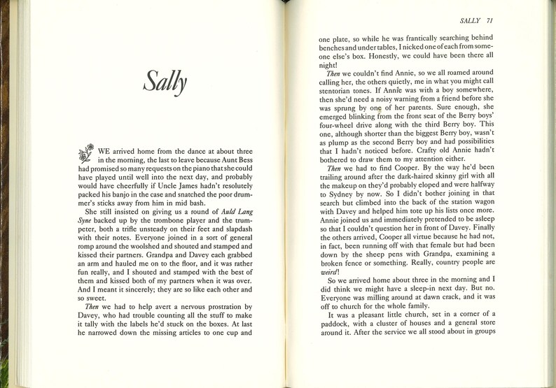 May include: Open book with text on both pages. The left page features the title "Sally" and a floral design. The right page has the number "71" at the top and continues the story. The pages are aged with a yellowed tone.
