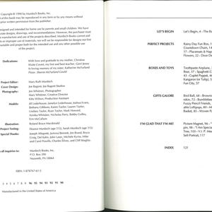 May include: Open book with text on the left and right pages. The left page includes copyright information, dedications, and credits. The right page lists the table of contents, including project names like "Autumn Wreath" and "Cookie Canmikin."