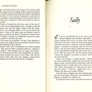 May include: Open book pages with text. The left page has the title "A NUGGET OF GOLD" and text. The right page has the title "Sally" and text. The text is in black font on a cream-colored background.