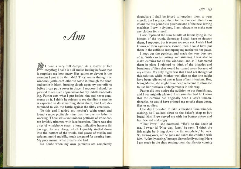 May include: Open book with text on both pages. The left page features the title "Ann" in cursive script and a block of text. The right page continues the text with the page number "115" at the top.