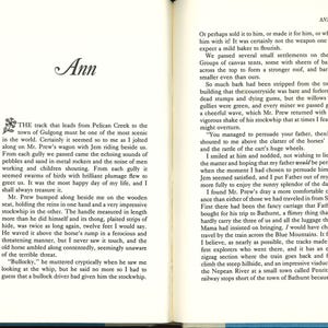 May include: Open book with text on aged paper. The word "Ann" is at the top of the left page. The text describes a journey with a stockwhip, with the handle measuring twelve feet. The right page has text as well.