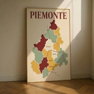 May include: A framed poster featuring a stylized map of the Piedmont region in Italy. The map is divided into colorful sections, with key cities like Turin, Alba, and Barolo labeled. The word "PIEMONTE" is printed in burgundy at the top.