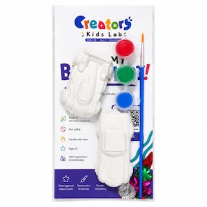 May include: A Creators Kids Lab craft kit featuring two white plaster car figures, three small circular paint pots in red, green, and blue, and a single blue-handled paintbrush. The packaging includes text, icons, and a QR code on a white card.