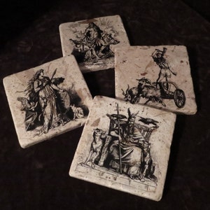 May include: Set of four square stone coasters with black and white illustrations of Norse mythology figures. The coasters feature images of Odin, Thor, Freya, and a valkyrie.