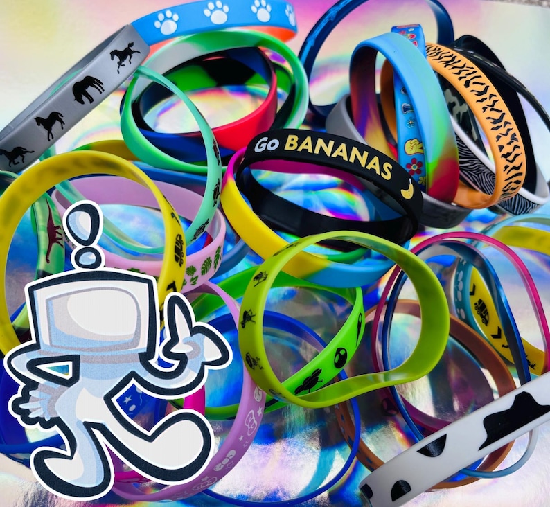 May include: A selection of colourful silicone wristbands with diverse designs. Some bands display paw prints, horses, and the text "Go BANANAS." The bands are available in various colours, including blue, green, yellow, and pink.