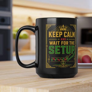 May include: A black ceramic mug featuring a yellow and green graphic design with the text "KEEP CALM AND WAIT FOR THE SETUP" above a candlestick chart illustration. The design includes a small crown icon and geometric border elements.