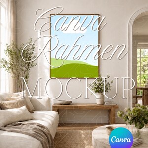 May include: A living room interior with a large framed artwork featuring a landscape of green hills and a blue sky with a cloud. The room includes a white sofa, wooden bench, and a round coffee table. The text "Canva Rahmen Mockup" is overlaid on the image.