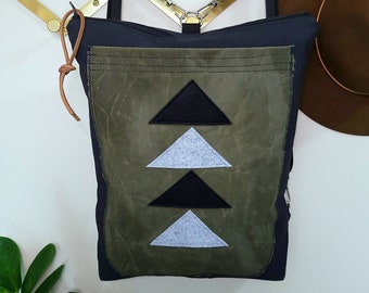 Backpack/Triangle felt applique=Large green waxed canvas front pocket/BLACK canvas shell/Black zipper/Black nylon straps/2 inside pockets