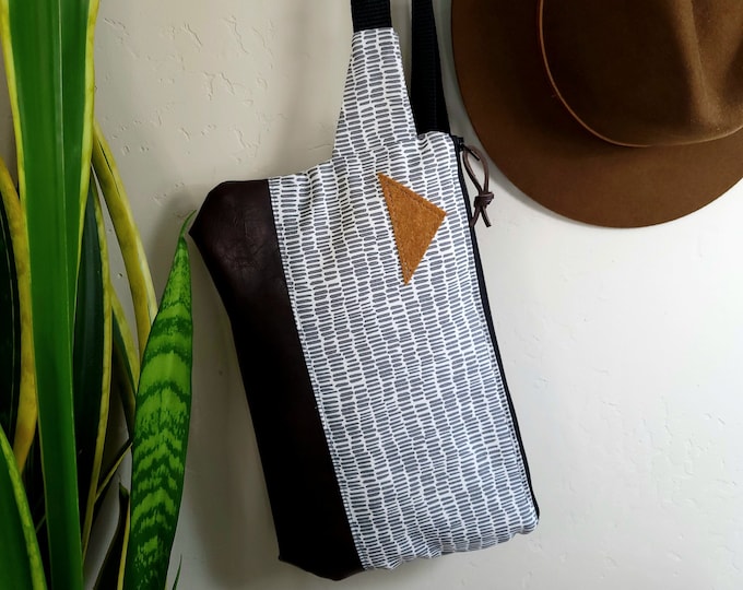 Sling bag/DASHING print gray and white = front and back/Black zipper/Black nylon adjustable & detachable strap/Felt triangle patch in rust