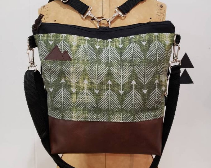 Convertible Backpack/Crossbody/Green feathered arrows print=2 front pockets/Black canvas/Black zip/Black adjustable nylon straps/MT or MT