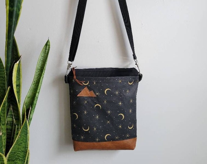 Medium crossbody/Charcoal and yellow MOONSHINE print front = pocket/Black zipper/Black canvas/Black nylon adjustable strap/Mountain or MT