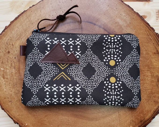 Mud cloth pouch/3 size options/printed front and back/Natural canvas liner/Black zipper/Mountain or Montana patch/Vegan leather details