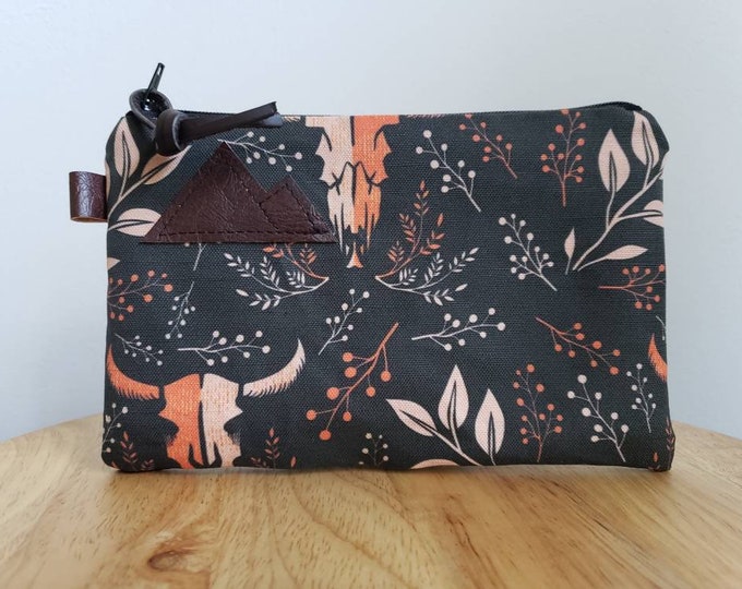 3 size options/Keep it wild print pouch/printed front and back/Natural canvas liner/Black zipper/Mountain or Montana patch