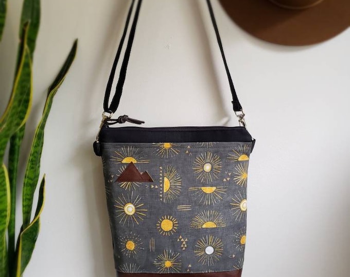 Medium crossbody/Shine print in charcoal = front pocket/Black zipper/Black canvas reverse/Black nylon adjustable strap/Mountain or MT patch