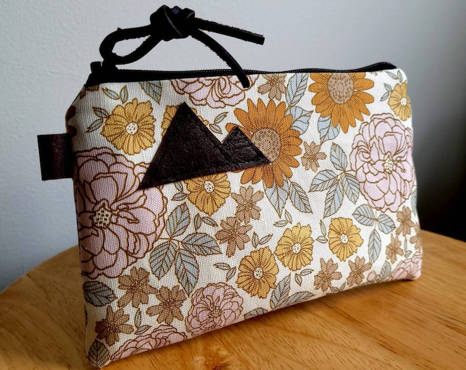 3 size options/VINTAGE FLORAL print= front and back/Natural canvas liner/Black zipper/Mountain or Montana patch