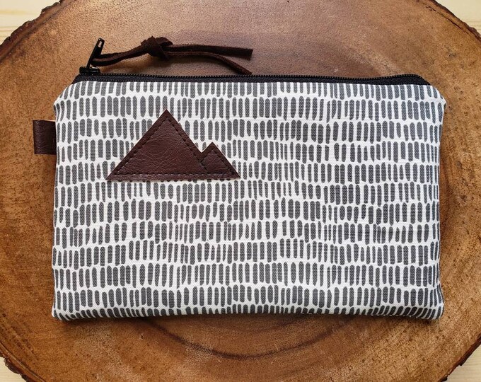 Gray & white dashing print/3 size options/printed front and back/Natural canvas liner/Black zipper/Mountain or Montana patch/Vegan leather