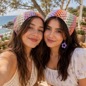 May include: A crochet headscarf featuring a multi-colored striped pattern in shades of purple, orange, pink, green, and cream. The headscarf is constructed with a classic granny square stitch pattern, creating a textured, open-weave design that covers the top of the head.