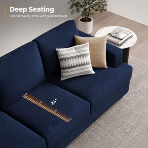 May include: A navy blue corduroy sectional sofa with three decorative pillows. The sofa has a deep seating area of 24 inches. The text "Deep Seating" and "Spend quality time with your beloved" are visible in the image.