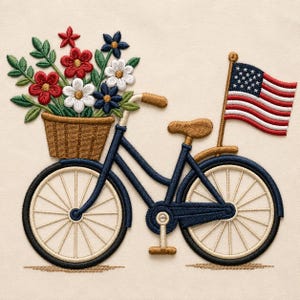 May include: An embroidered design of a dark blue bicycle with a brown basket filled with red, white, and blue flowers. A small American flag is attached to the rear of the bicycle. The bicycle features tan wheels and a tan seat on a cream background.