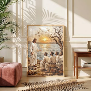 May include: A framed wall art print depicting a figure in a white robe standing on a rocky shore, gesturing toward a group of four seated figures. The scene features a calm body of water, a golden sunset, a bare tree, and birds in flight.