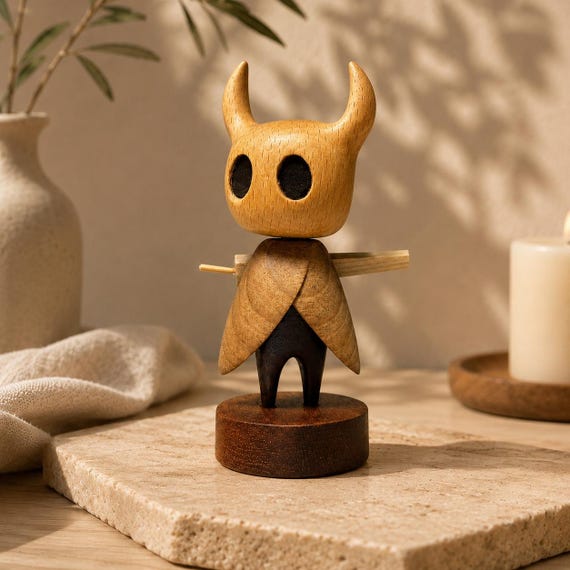 A hand-carved walnut sculpture of the Hollow Knight with magnetic assembly — a tactile, artisan collectible that's worlds above any mass-produced figure.
