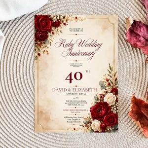 May include: A rectangular invitation card for a 40th Ruby Wedding Anniversary featuring deep red and cream floral arrangements in the corners. The text reads: Ruby Wedding Anniversary, 40th, David & Elizabeth, Saturday July 18, 5:30 PM, The Grand Ballroom, 245 Garden View Avenue, New York, NY 10001, Kindly Reply Before July 10, (555) 246-8190, Celebrating Forty Years of Love, Laughter & Beautiful Memories.