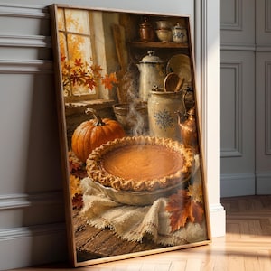 May include: A framed painting depicting a steaming pumpkin pie on a rustic wooden table with a whole orange pumpkin, autumn leaves, and a kitchen scene in the background featuring ceramic crocks, a copper kettle, and a window with fall foliage.