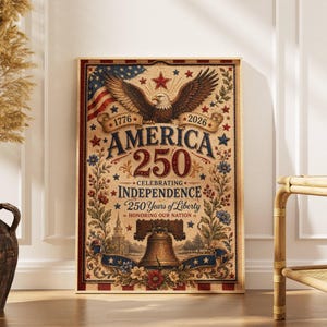May include: A framed print celebrating America's 250th anniversary of independence. The design features an eagle, the American flag, and the Liberty Bell, with text that reads "America 250 Celebrating Independence 250 Years of Liberty". The color palette includes red, white, blue, and tan.