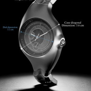 May include: A silver wristwatch with a distinctive, curved shape. The dial is 3.2 cm, and the case diagonal is 3.6 cm. The strap is 1.9 cm wide. The watch face includes the text "START/STOP 1" and "I ISTIMODE".