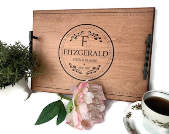 May include: A wooden serving tray with black metal handles. The tray is engraved with a monogram and the text "Fitzgerald, John & Elaine, Est. 1997".