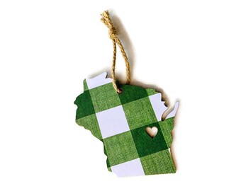 May include: Green and white checkered Wisconsin state ornament with a small heart cutout. The ornament is made of wood and has a twine hanger.