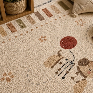 Puede incluir: Una alfombra texturizada de color crema con un borde repetitivo de peque&ntilde;os bloques rectangulares en tonos tierra apagados. El centro muestra un oso de dibujos animados sosteniendo un globo rojo, junto a motivos de estrellas y flores.