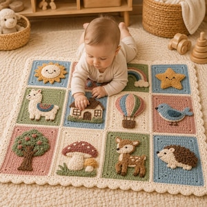 May include: A square crochet baby blanket featuring twelve distinct textured squares with appliqués of a sun, rainbow, star, llama, house, hot air balloon, bird, tree, mushrooms, deer, and hedgehog in soft pastel and earthy tones.