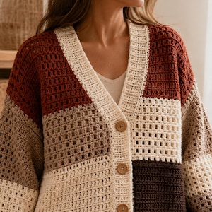 May include: A color-blocked crochet cardigan featuring a V-neckline and three brown buttons. The garment is constructed with a grid-like stitch pattern in alternating sections of cream, rust orange, light brown, and dark brown yarn colors.