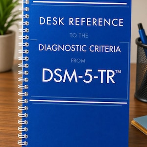May include: A blue spiral-bound book titled Desk Reference to the Diagnostic Criteria from DSM-5-TR. The cover features white text and horizontal lines against a solid blue background, with a metal coil binding along the left side of the book.