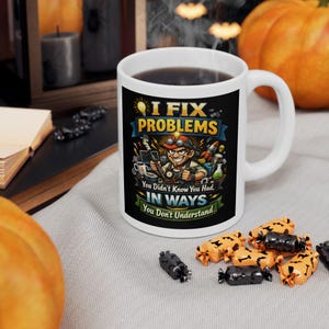 May include: White ceramic mug with a black graphic that reads "I FIX PROBLEMS" with a cartoon image of a man with goggles. The mug also has the text "You Didn't Know You Had, IN WAYS You Don't Understand."