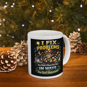 May include: White ceramic mug with a black graphic featuring the text "I FIX PROBLEMS" and "You Didn't Know You Had, IN WAYS You Don't Understand." The design includes a cartoon image of a technician with tools.