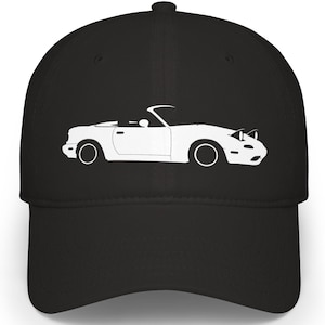 May include: Black baseball cap with a white outline of a convertible car. The car design includes headlights, wheels, and a convertible top. The cap has a curved peak and a structured crown, suitable for car enthusiasts.