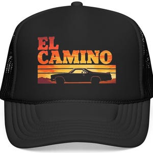 May include: Black trucker hat featuring the text "EL CAMINO" in orange and red, with a silhouette of a car against a sunset backdrop. The hat has a mesh back and a curved brim.