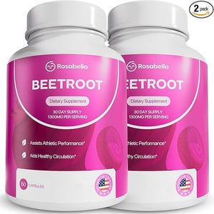 Puede incluir: Dos botellas blancas de suplemento con etiquetas rosas. Las etiquetas dicen "Rosabella BEETROOT Dietary Supplement" con texto que indica un suministro para 30 días y 1300 mg por porción. Las botellas están marcadas con "60 CAPSULES" y "2 pack".