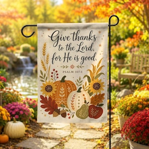 May include: A rectangular garden flag featuring the text Give thanks to the Lord, for He is good and Psalm 107:1. The design includes illustrations of orange and white pumpkins, sunflowers, wheat stalks, red berries, and autumn leaves.