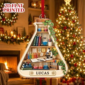 May include: A 2D flat printed Christmas ornament shaped like a laboratory flask, featuring shelves with books, test tubes, a microscope, and plants. The text 2D FLAT PRINTED appears at the top, and the name LUCAS is printed on a banner at the bottom.